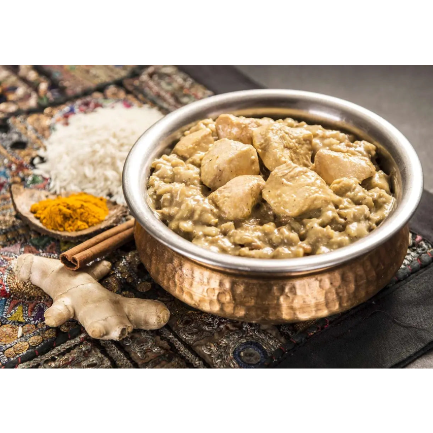 Bowl of food with rice and chicken on a textured surface