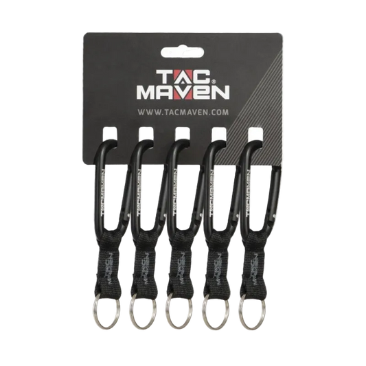 Four black carabiner keychains with black webbing and silver keyrings, attached to a black TAC MAVEN retail card on a white background.
